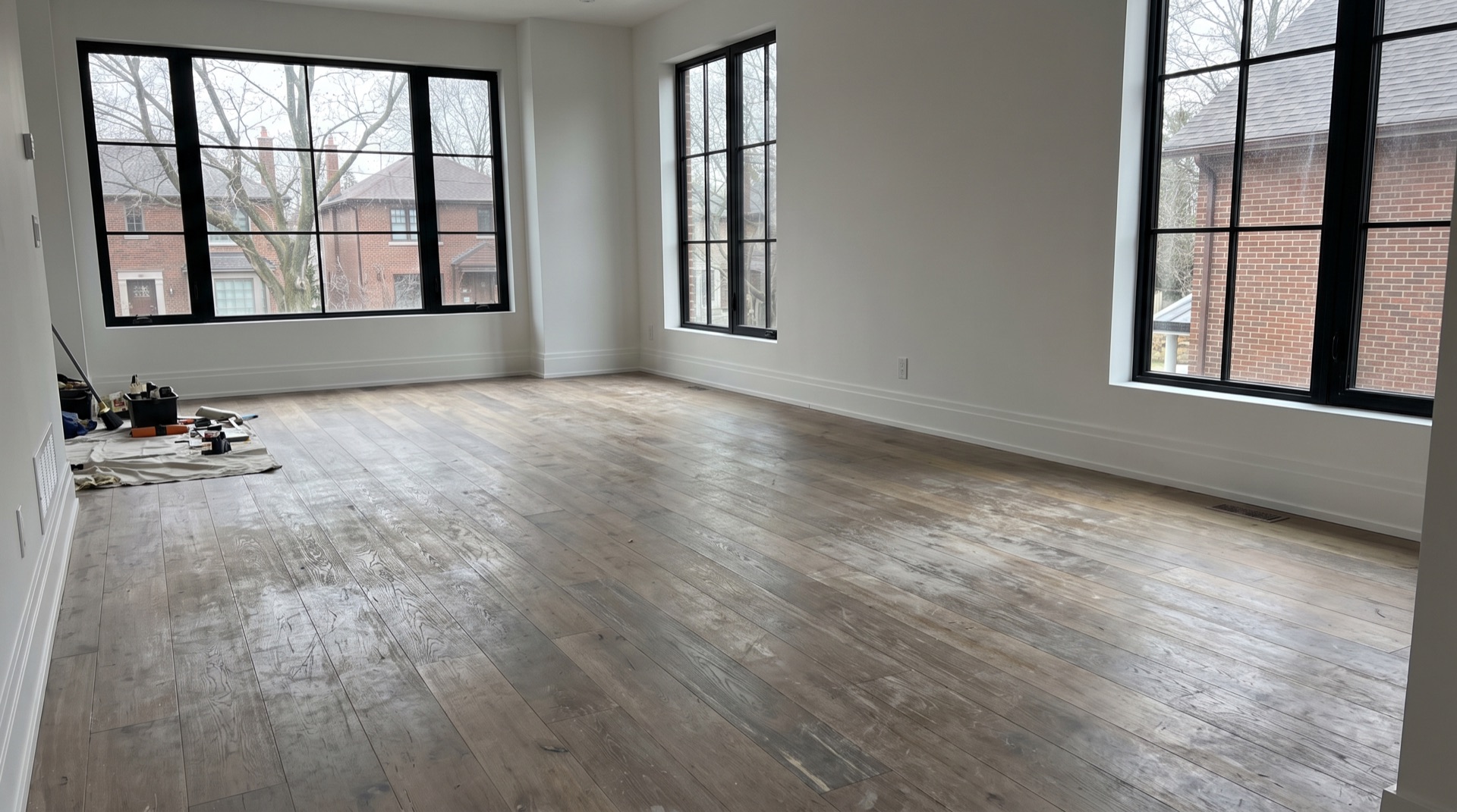 Worn oak floor with decades of scratches and faded finish